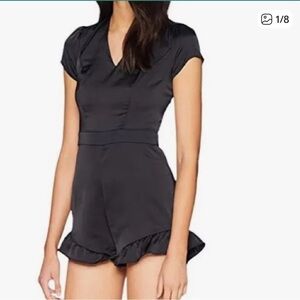 Bebe Black Satin Romper with Ruffle Hem